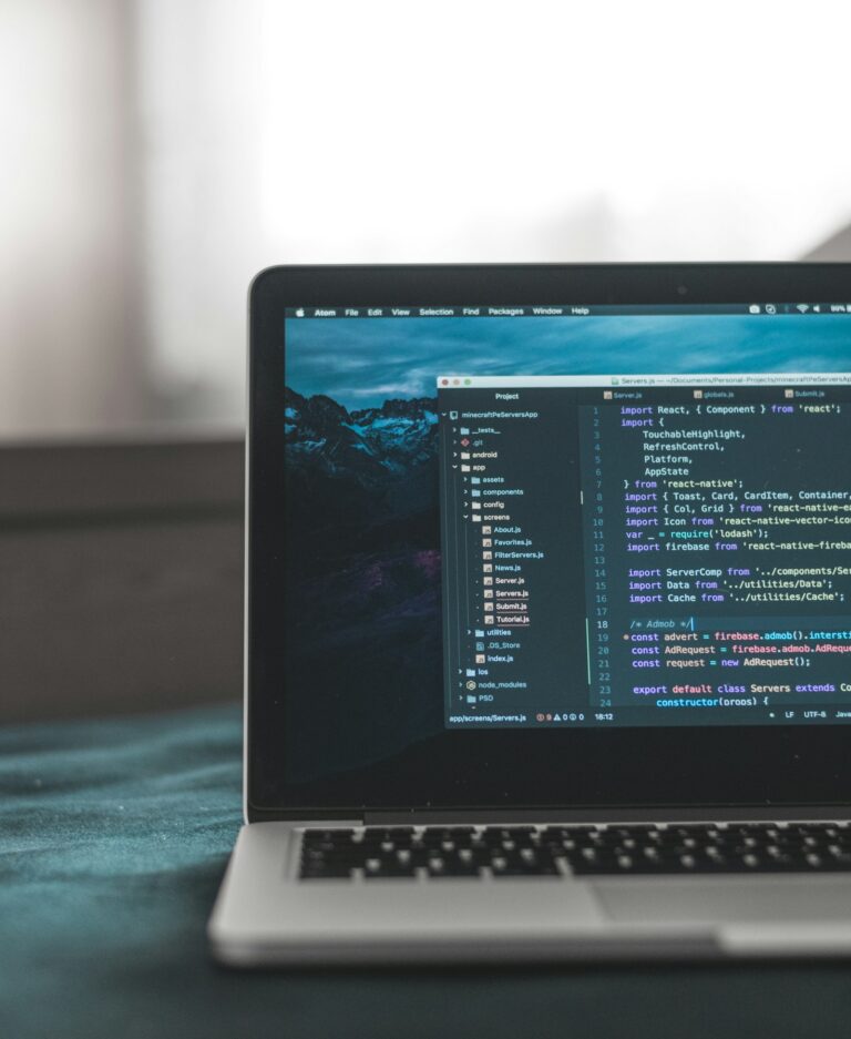 A laptop screen displaying lines of programming code, representing website development work.